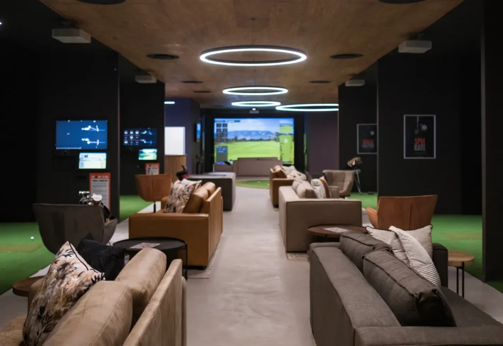 Image showing Par 72's 8 premium trackman virtual golf bays complimented by leather couch seating and a mini indoor putting green — Par 72 virtual golf opens in Pretoria.